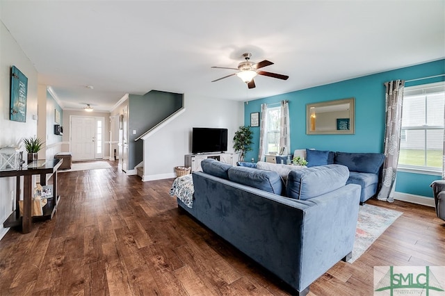 living room featuring ceiling fan and dark wood-type flooring