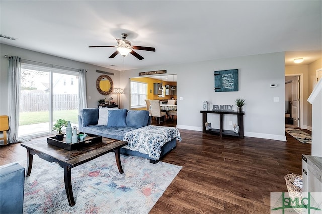 living room featuring dark hardwood / wood-style floors and ceiling fan