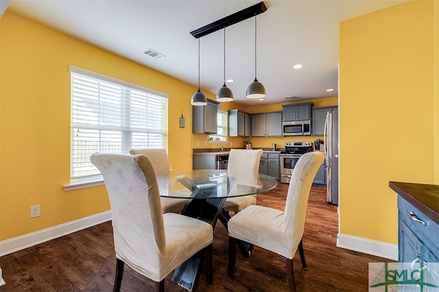 dining room with dark hardwood / wood-style flooring