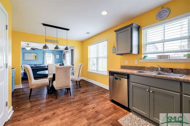 kitchen featuring gray cabinetry, dishwasher, sink, dark hardwood / wood-style flooring, and pendant lighting