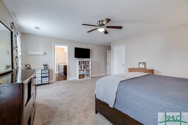 bedroom featuring carpet floors, ensuite bath, and ceiling fan