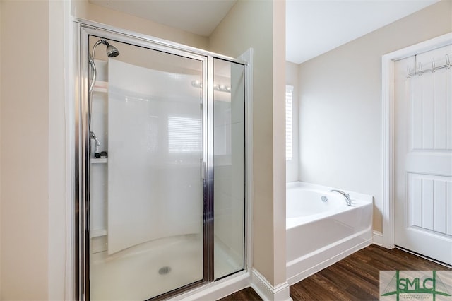 bathroom with wood-type flooring and independent shower and bath