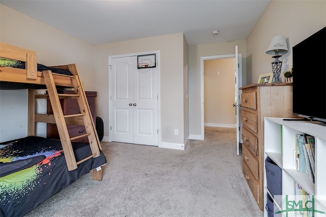 bedroom featuring light carpet and a closet