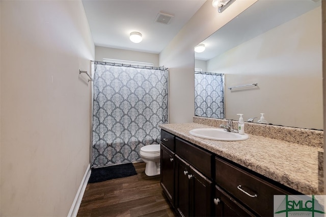 bathroom with vanity, hardwood / wood-style flooring, and toilet