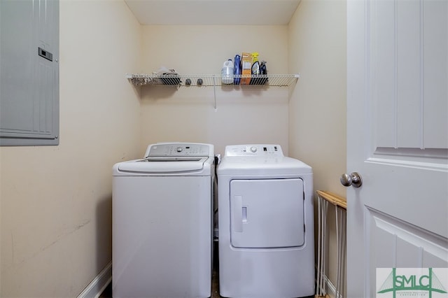 washroom with electric panel and washer and dryer