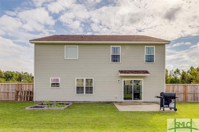 back of house with a garden, fence, a lawn, and a patio area