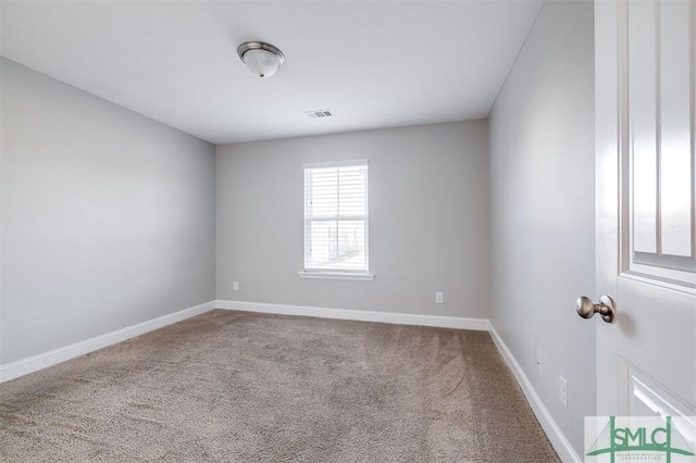 empty room featuring visible vents, carpet, and baseboards