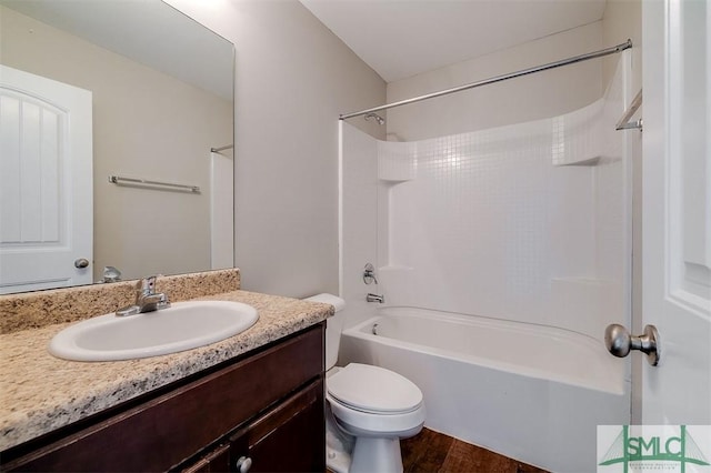 full bath with shower / bathtub combination, toilet, vanity, and wood finished floors