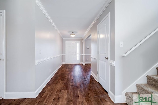 entryway featuring crown molding, stairs, baseboards, and wood finished floors