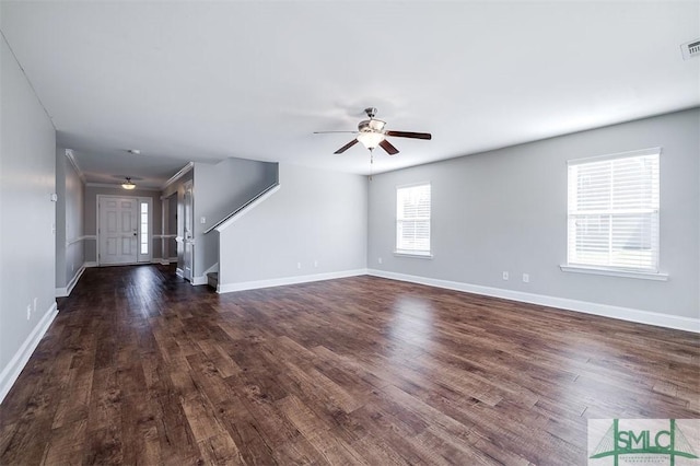 unfurnished living room featuring a ceiling fan, visible vents, dark wood-style floors, and baseboards