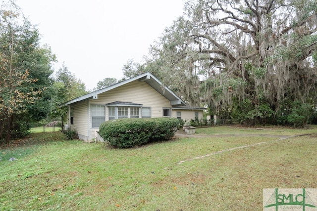 view of property exterior featuring a lawn