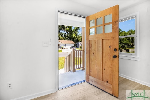 doorway with light wood-type flooring