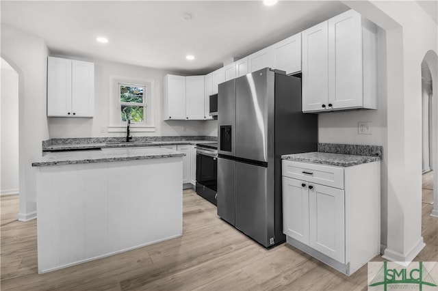 kitchen featuring white cabinets, stainless steel appliances, light hardwood / wood-style flooring, and sink