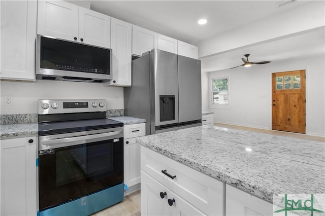 kitchen with ceiling fan, light stone countertops, light hardwood / wood-style floors, white cabinetry, and stainless steel appliances