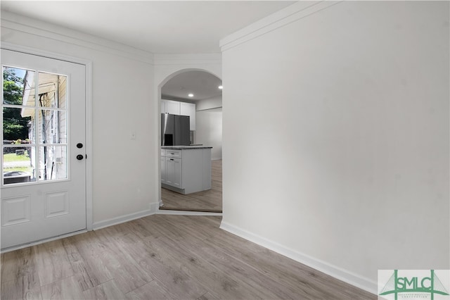 entryway featuring light hardwood / wood-style flooring and crown molding