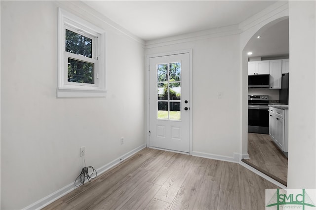 doorway to outside featuring light hardwood / wood-style floors and ornamental molding