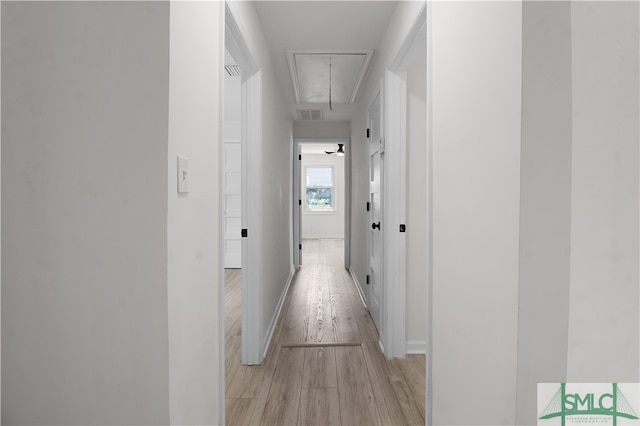 corridor with light hardwood / wood-style floors