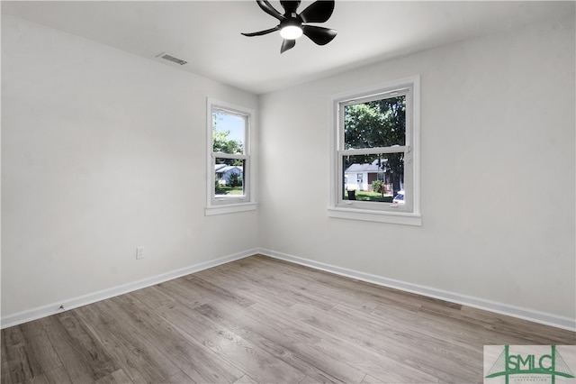 empty room with ceiling fan and light wood-type flooring