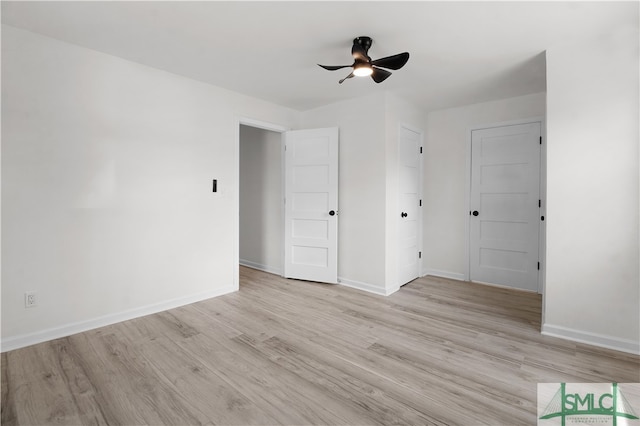 empty room with light wood-type flooring and ceiling fan