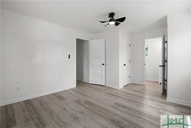 spare room with light hardwood / wood-style floors and ceiling fan