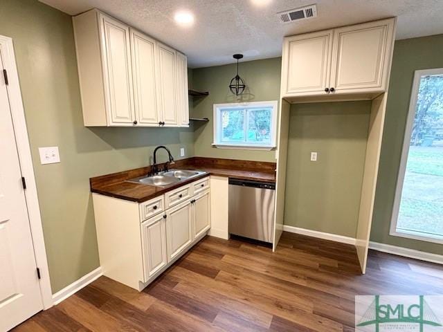 kitchen with white cabinetry, dishwasher, sink, dark hardwood / wood-style floors, and a textured ceiling