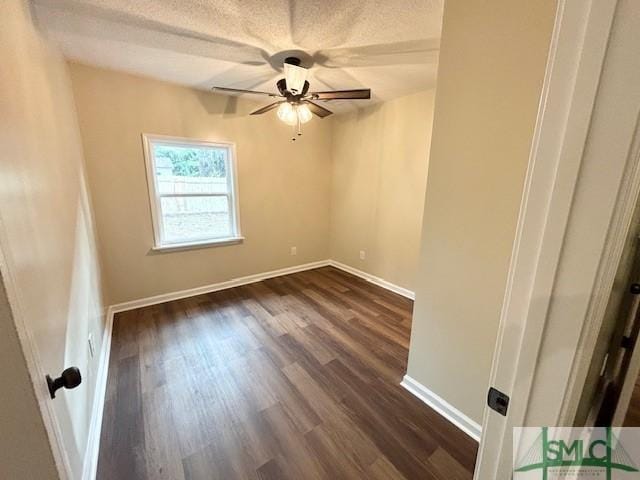 unfurnished room featuring a textured ceiling, dark hardwood / wood-style flooring, and ceiling fan