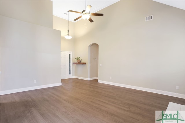 unfurnished living room with dark hardwood / wood-style floors, high vaulted ceiling, and ceiling fan