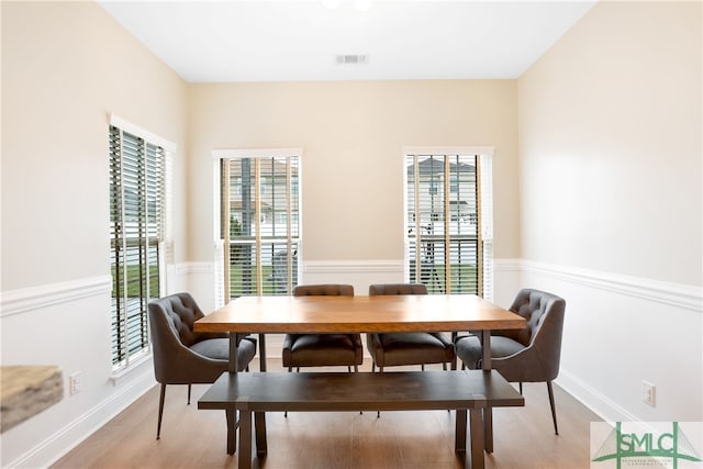 dining area with a healthy amount of sunlight and light hardwood / wood-style floors