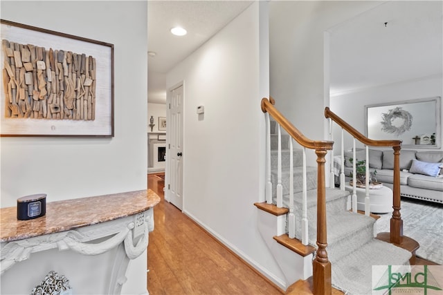 stairway with hardwood / wood-style flooring