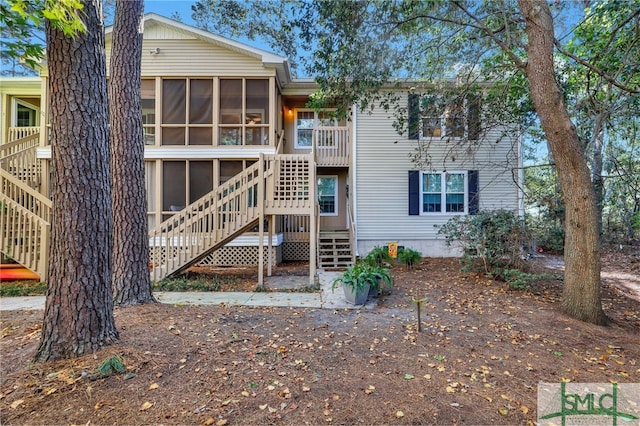 back of property with a sunroom