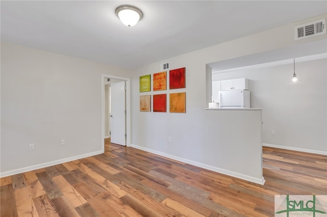 spare room with wood-type flooring