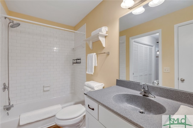 full bathroom featuring vanity, toilet, and tiled shower / bath