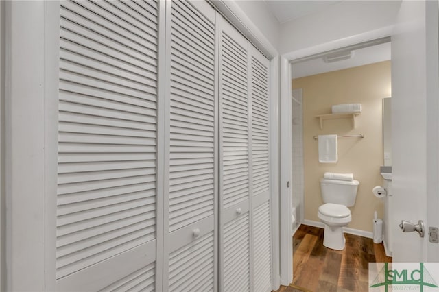 bathroom featuring hardwood / wood-style floors and toilet