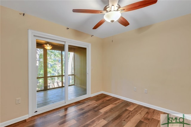 spare room with ceiling fan and dark hardwood / wood-style floors