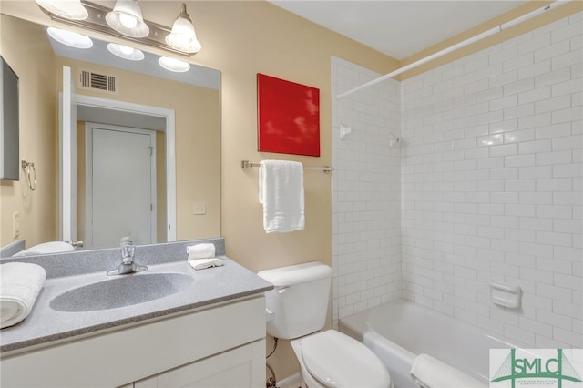 full bathroom featuring vanity, toilet, and tiled shower / bath combo