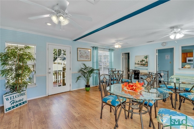 dining room featuring light hardwood / wood-style floors and crown molding