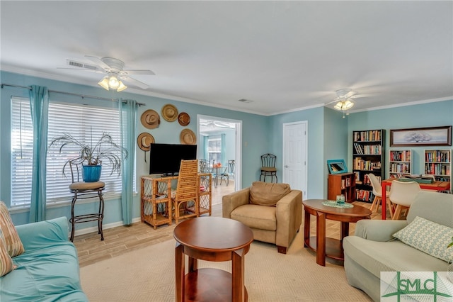 living room featuring light hardwood / wood-style floors, ceiling fan, and crown molding