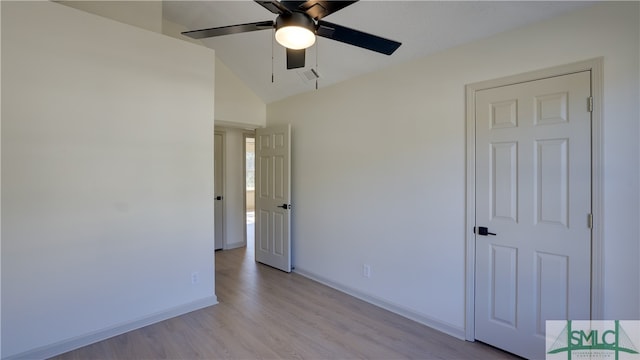 spare room with ceiling fan, light hardwood / wood-style floors, and vaulted ceiling