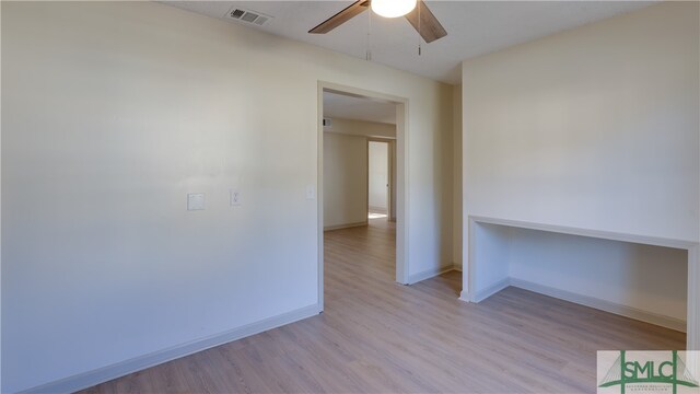 spare room with ceiling fan and light hardwood / wood-style floors