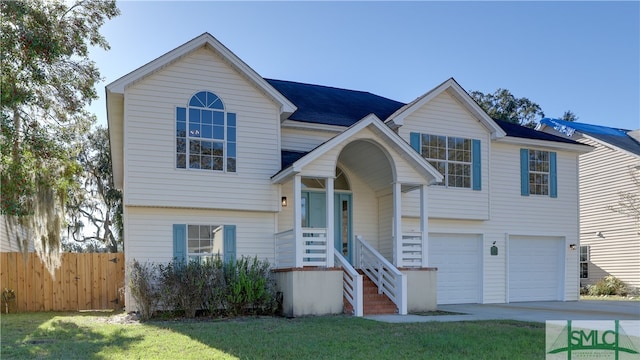 split foyer home with a garage and a front lawn