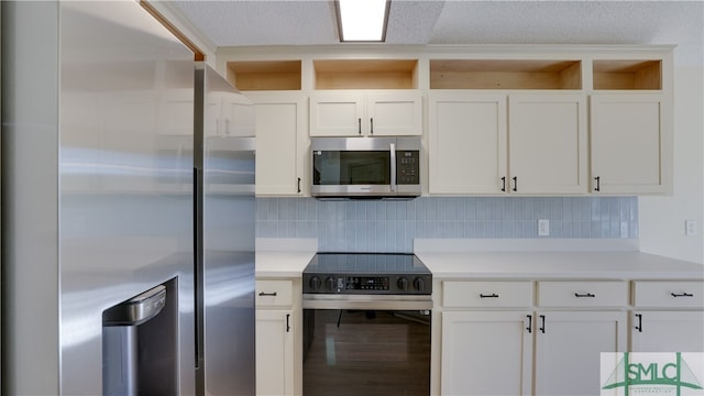 kitchen featuring tasteful backsplash, white cabinetry, hardwood / wood-style floors, and stainless steel appliances