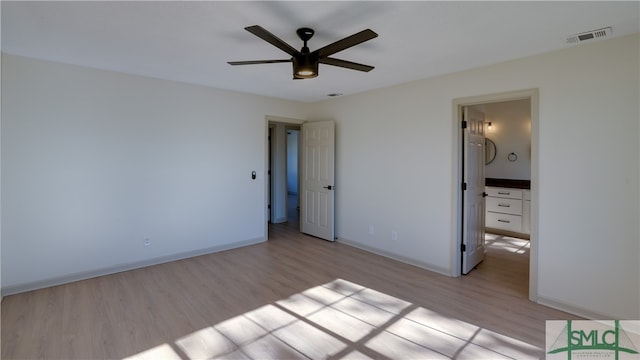 unfurnished bedroom featuring ceiling fan, connected bathroom, and light hardwood / wood-style flooring