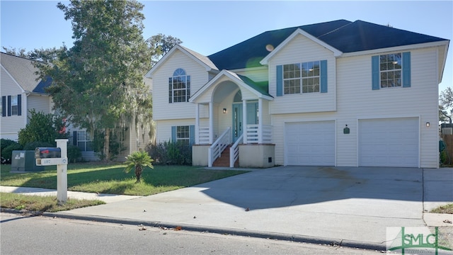 split foyer home with a garage and a front yard