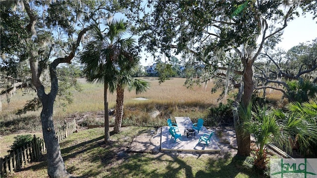 view of yard featuring a patio and a fire pit