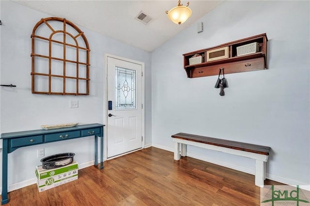 foyer with vaulted ceiling and dark wood-type flooring