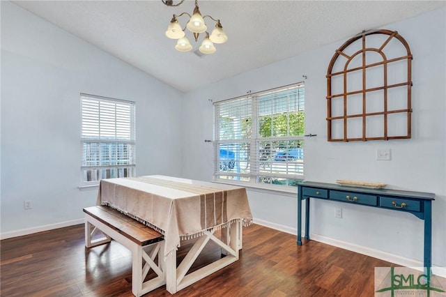 dining space with vaulted ceiling, a wealth of natural light, a chandelier, and dark hardwood / wood-style floors