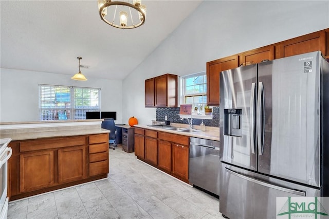 kitchen with decorative light fixtures, sink, decorative backsplash, and stainless steel appliances