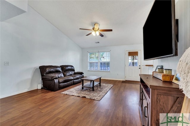 living room featuring ceiling fan, dark wood-type flooring, and lofted ceiling