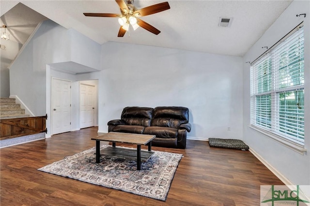 living room featuring ceiling fan, vaulted ceiling, and dark hardwood / wood-style floors