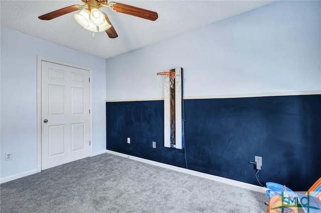 unfurnished bedroom featuring ceiling fan, a textured ceiling, and carpet flooring